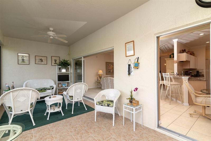 The lanai is accessible via the triple slider in the living room and the double slider in the dinette.