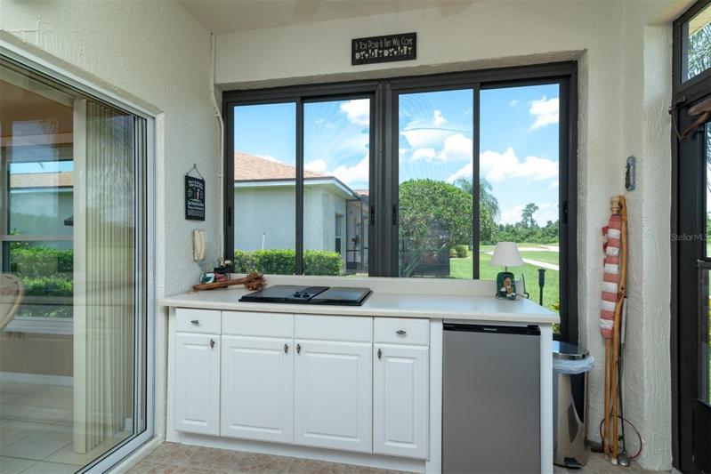 The summer kitchen has a Jenn Air grill and refrigerator.