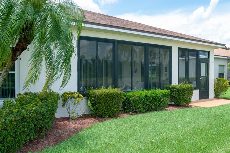 The covered and enclosed lanai has slider windows with screens.