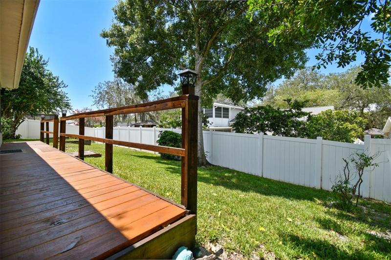 A newer, low maintenance vinyl fence adds privacy and keeps the kids and pets wrangled