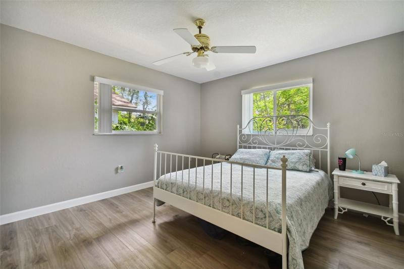 Cue the light (and not the carpet) in this generous sized guest bedroom located at the front of the house across from the living room