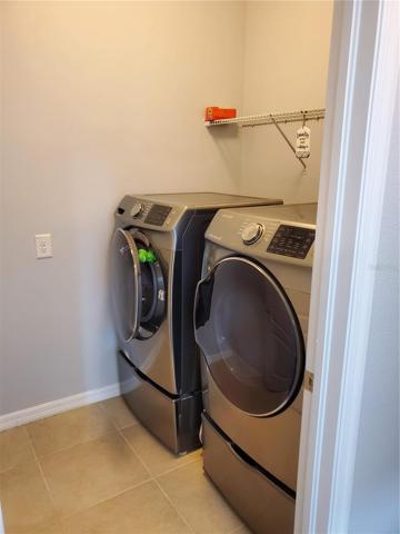 laundry room with plenty of storage