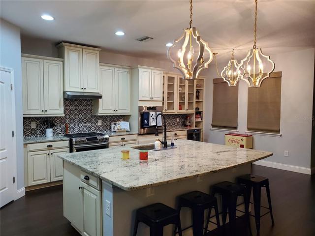 Welcome to this gorgeous chef's kitchen with a massive island and seating for at least 4 people.