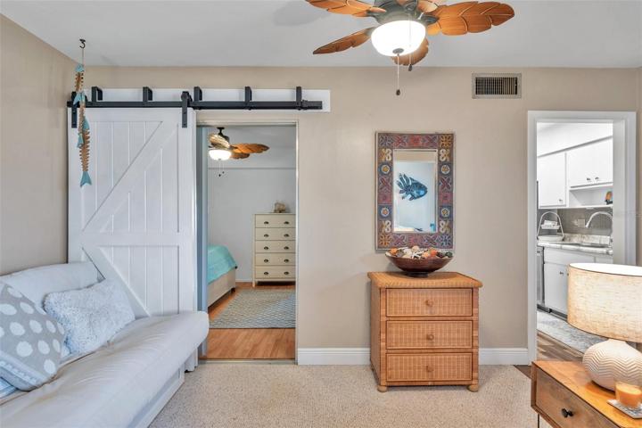 Barn door for privacy and bed for guests