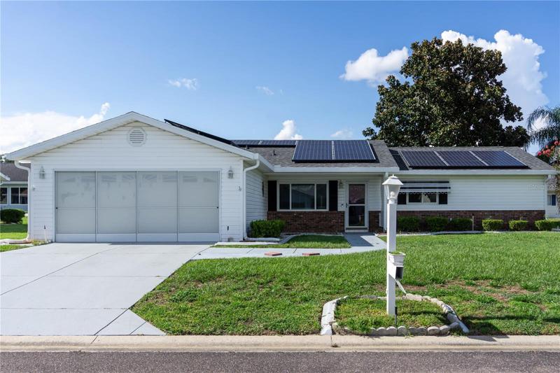 A retiree's dream located on a gated golf course with private mailbox, NEWER ROOF, SOLAR PANELS, garage screen enclosure, and mature shrubbery, that provide an inviting and old Florida feel all within this active 55+ community with LOTS of fun amenities!