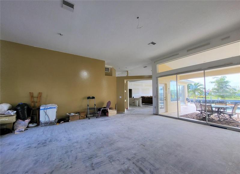 Huge Great Room has triple sliding doors and transom window to let in plenty of light and enjoy the view