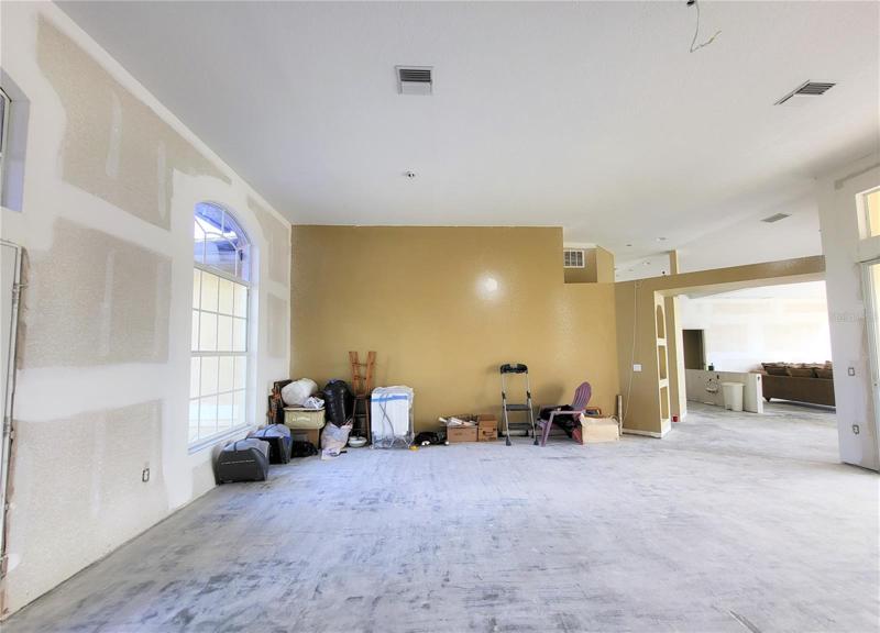 Tall windows and leaded glass double entry doors add to the natural lighting