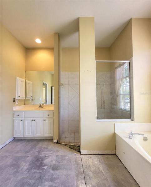 Tiled walk-in shower has large glass to let in the light