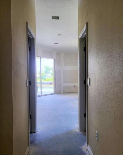 Hallway to Master Bedroom, flanked by two walk-in closets