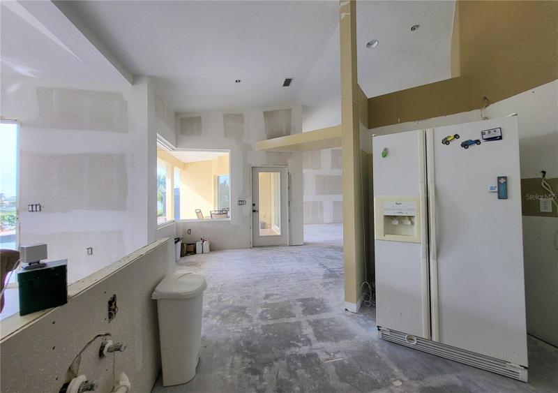 Plumbing is located on the half wall, and a new countertop could extend to a breakfast bar on the other side