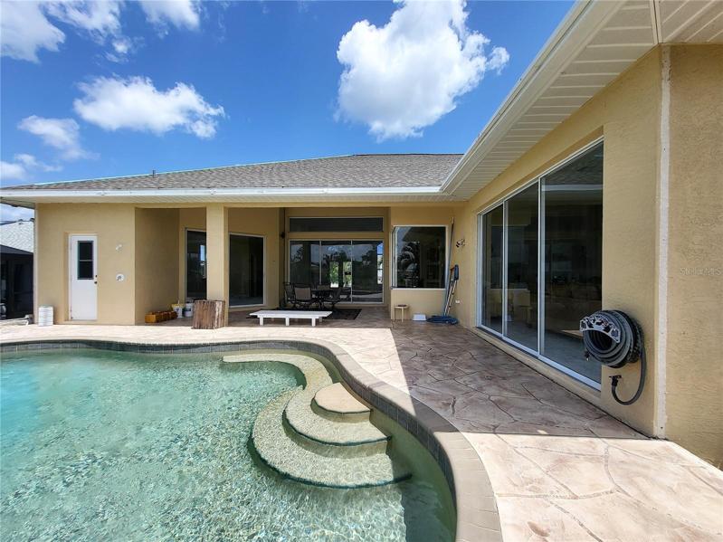 Pool has built-in seating to sit and enjoy the river view