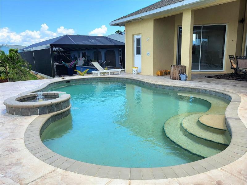 Beautiful free-form pool, with fountain feature. Door in upper center is to the half bath, for convenience
