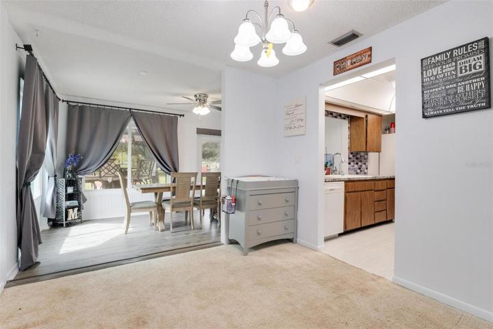 Dining area leading to kitchen and bonus room.
