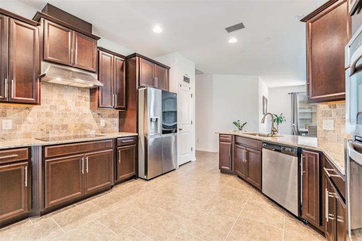 Spacious kitchen with tile floors and backsplash
