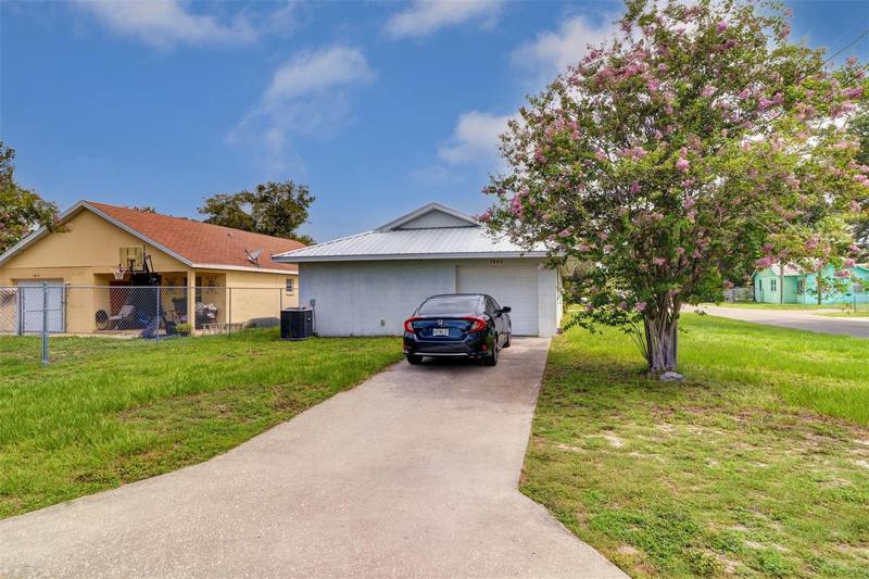 Concrete drive on rear of home with plenty of parking & 1-car garage