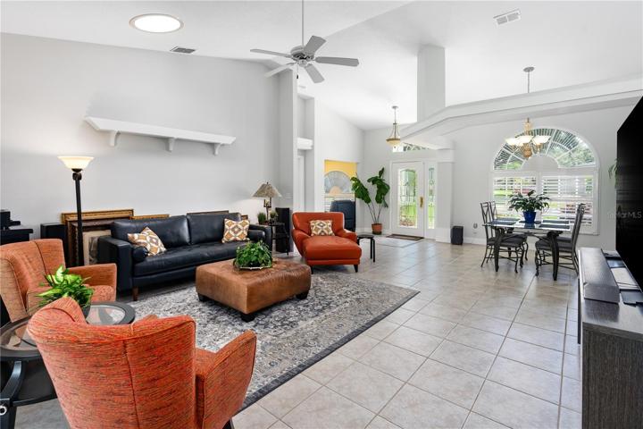 Living Room light and bright with volume ceilings.