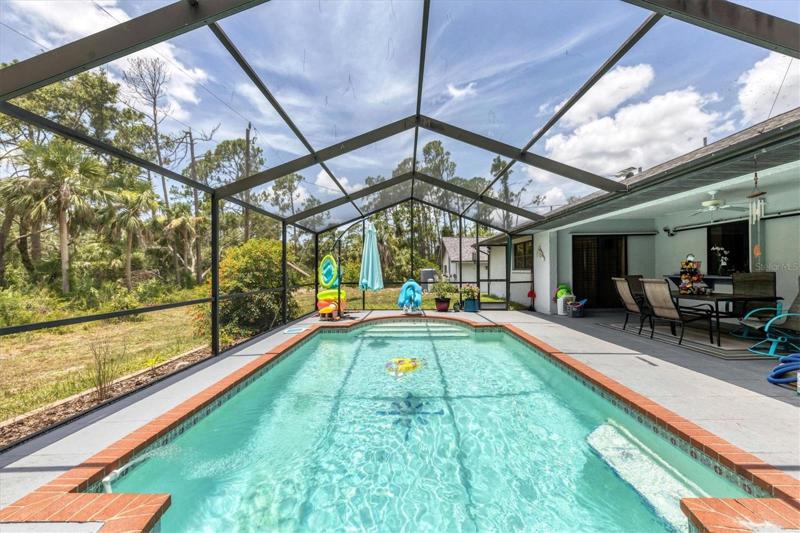 VIEW SHOWING YARD, LANAI AND POOL
