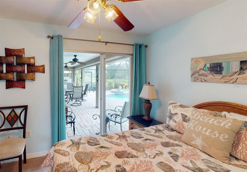 Guest bedroom 3 with sliders to the pool deck