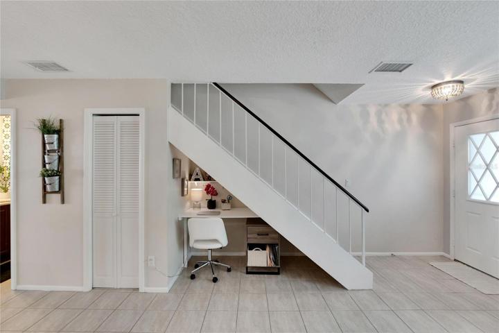 Utilization of every space; cute office desk under the stairs.