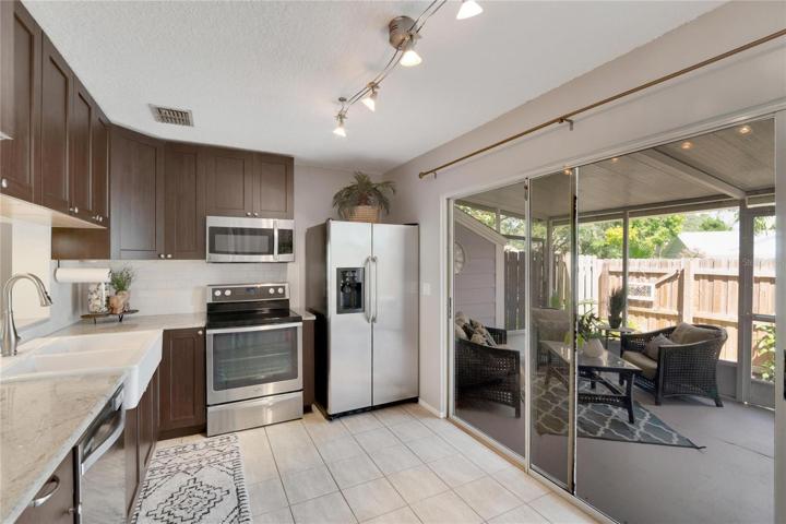 Large sliding glass doors to patio with additional dog door panel added!
