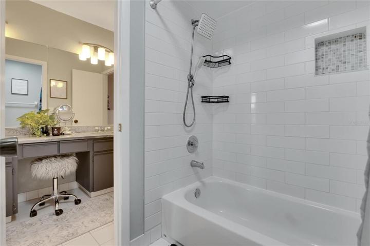 Shower/tub combo with new tile surround.