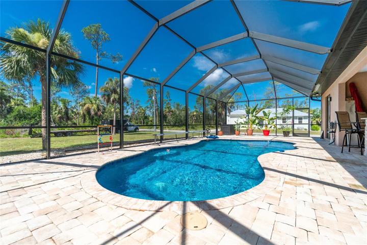 Paved lanai with heated saltwater pool