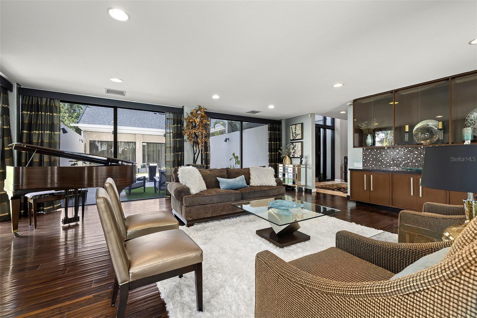 FAMILY ROOM WITH VIEWS ON BOTH SIDES / POOL COURTYARD AND LAKEVIEW COURTYARD