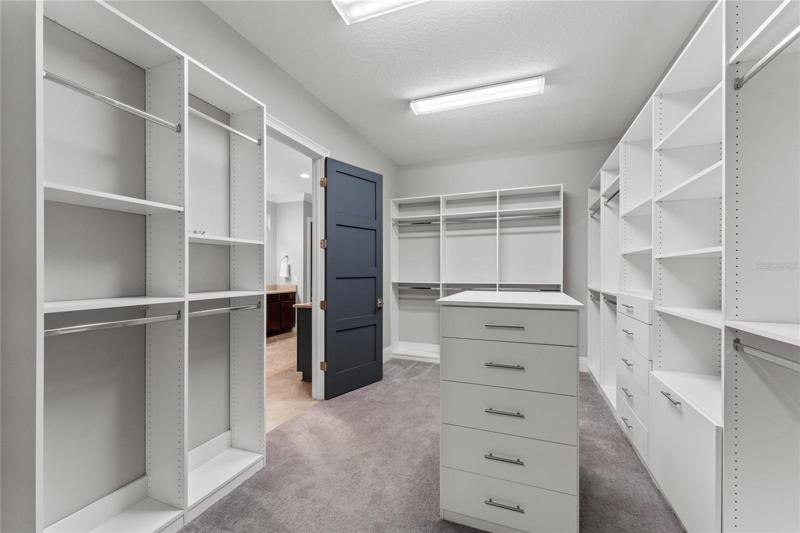 Primary bedroom walk-in closet