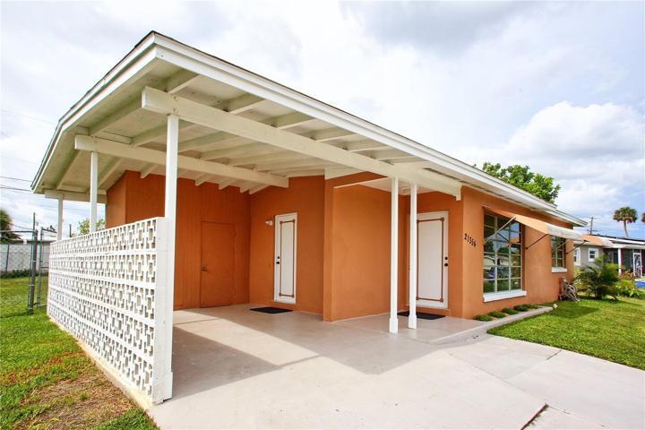 Front entry with car port and storage behind. Door in car port goes directly to laundry and kitchen