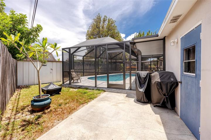 Backyard With Small Aluminum Shed Off Of Utility Room