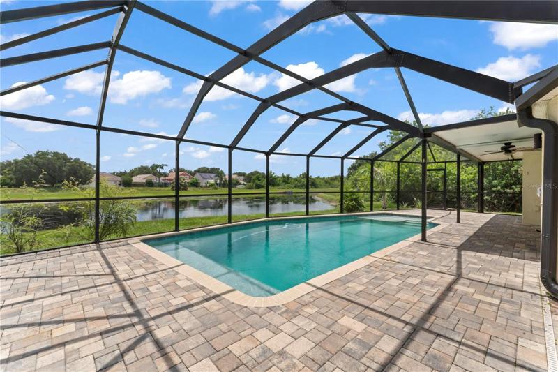 Private pool overlooking water view from pond.
