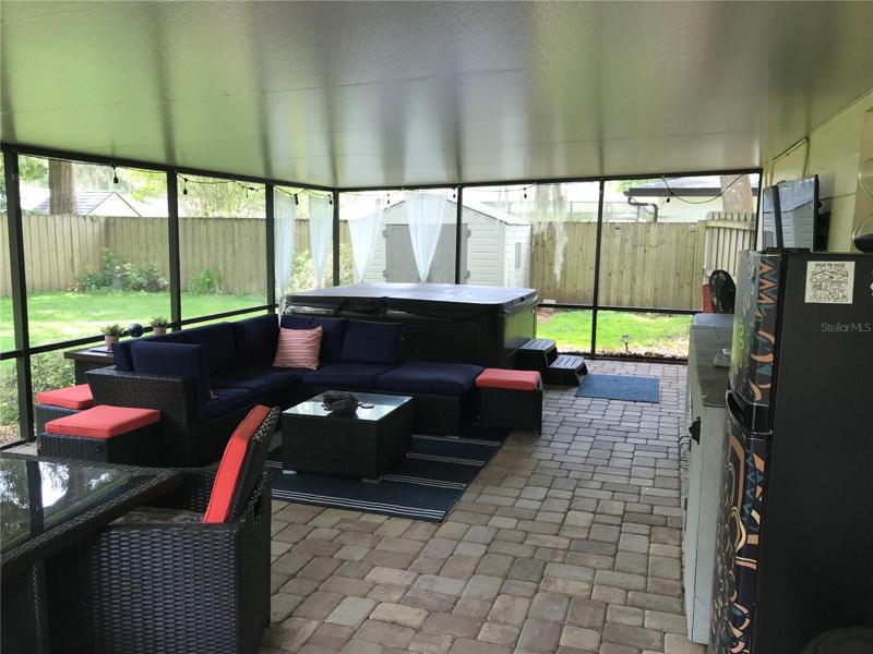 back screen enclosed pation with hot tub