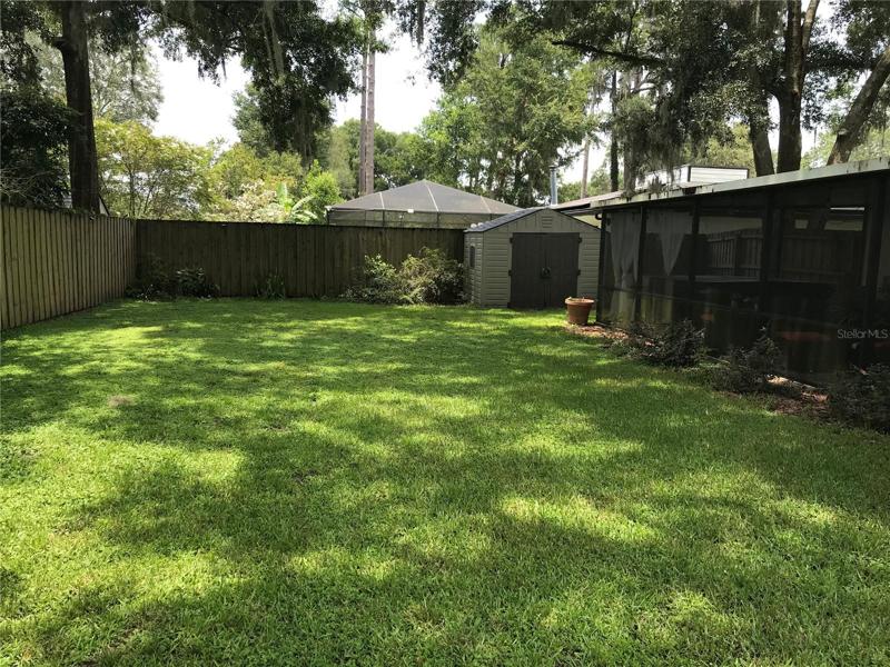 lush back yard with storage shed