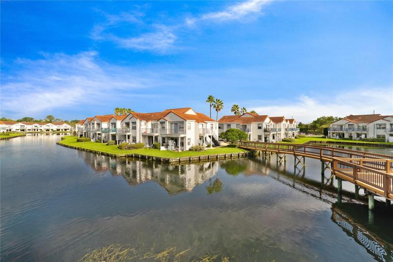Welcome to Dockside in the established Ventura Lakes community and this beautiful 2 bedroom, 2 bath **CORNER UNIT** for an abundance of NATURAL LIGHT and stunning VIEWS of the COMMUNITY LAKE!