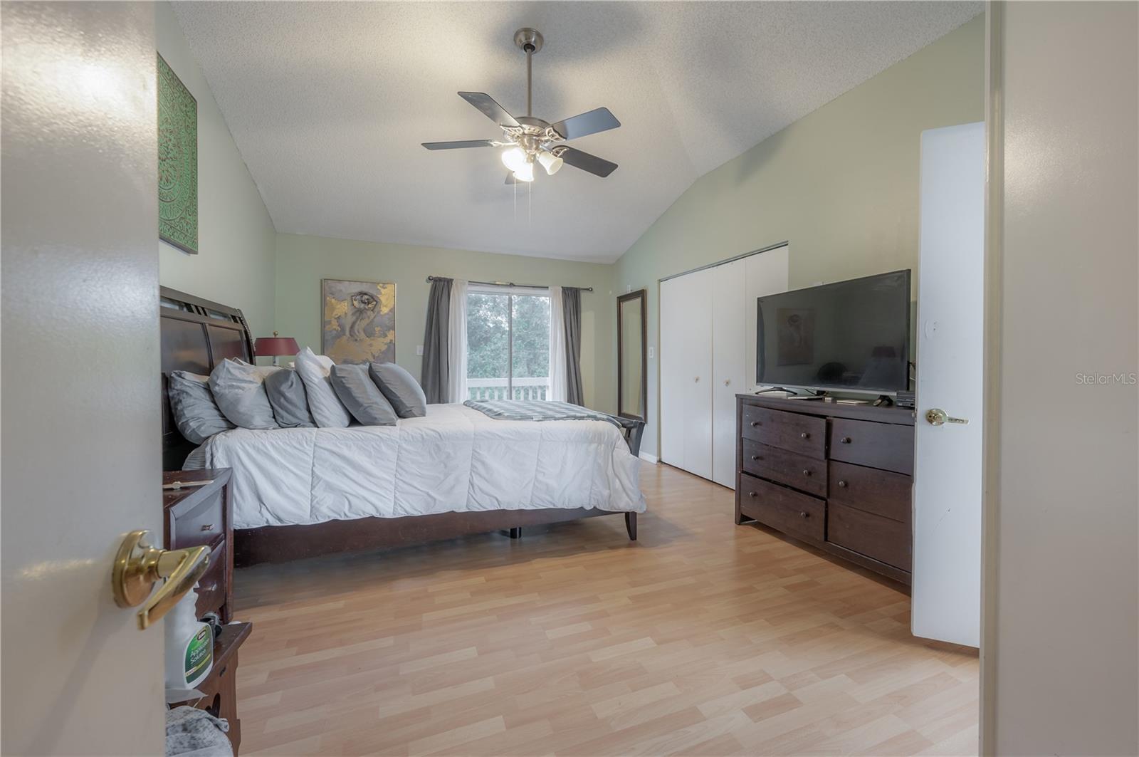 Primary Suite with en suite bath, walk-in closet, balcony with views of conservation and pond