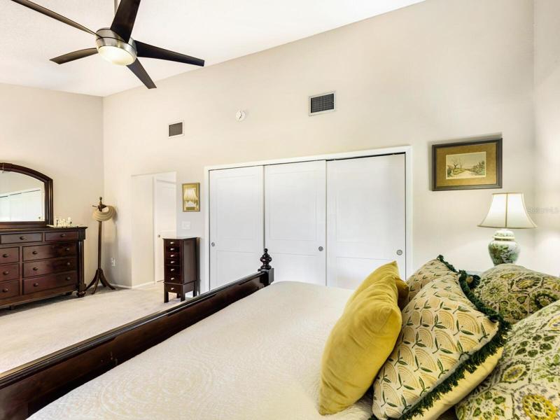 Master Suite has vaulted ceiling, contemporary ceiling fan with light, new verticals and custom closets