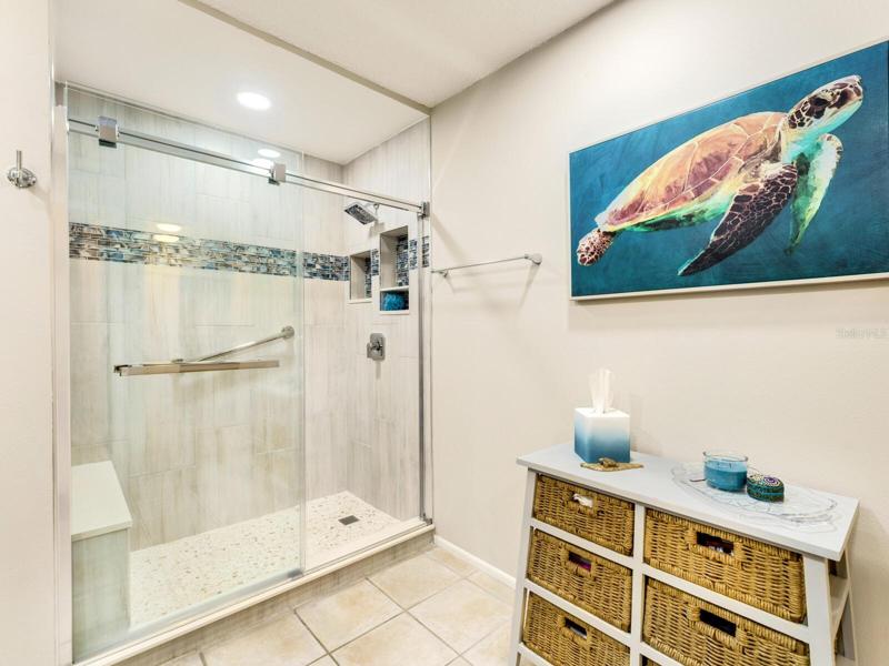 You'll love the new beautiful walk-in shower with designer glass tile inserts & new glass shower door.