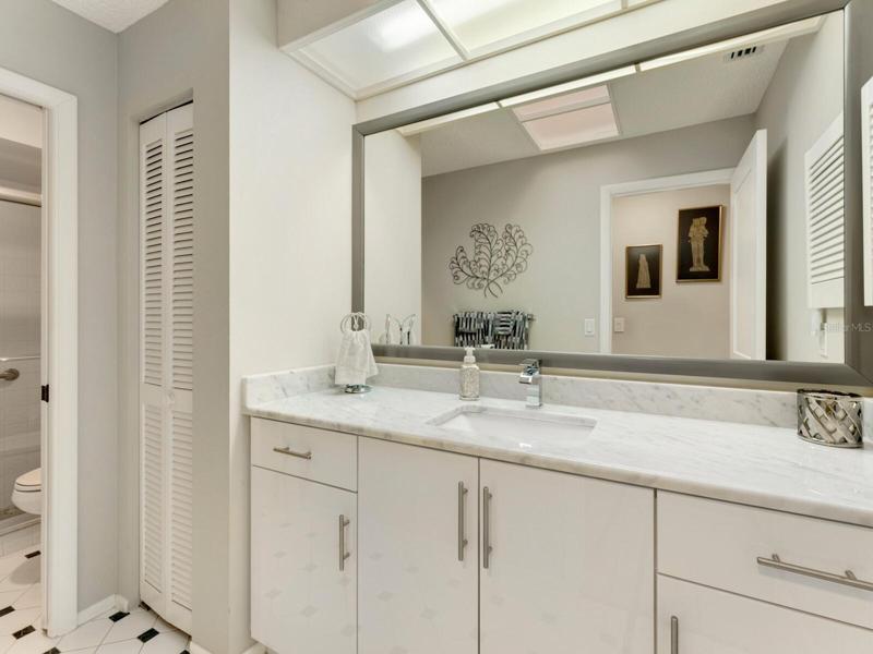 Stunning second bath with marble vanity & large picture mirror.