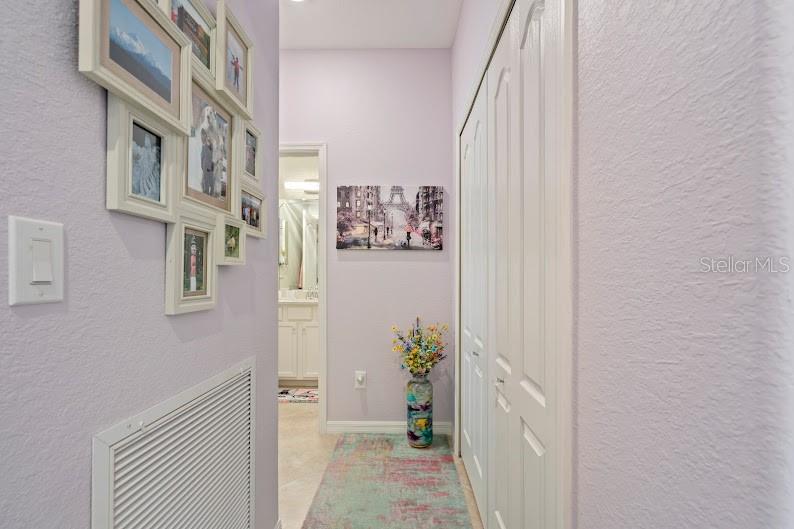 Hall off of entryway, leading to 3rd bedroom/den &amp; 3rd full bath