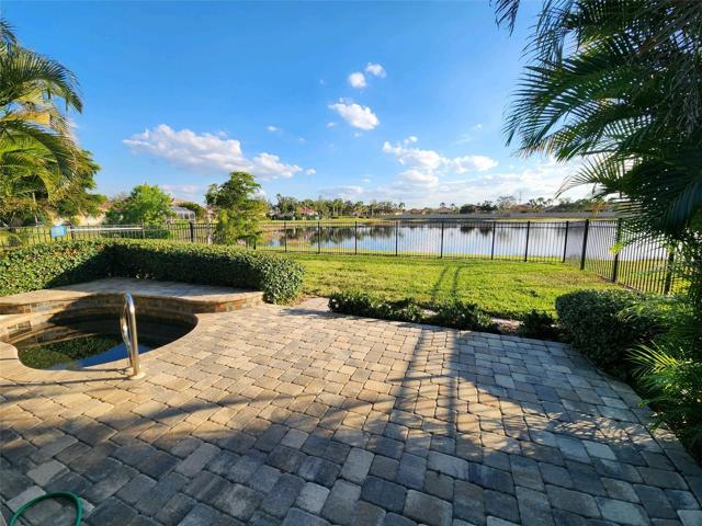 pristine landscape with a privacy-sensitive in-ground spa and fenced backyard