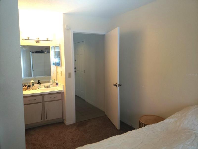 Dressing Area next to Bathroom; Hallway leading to Front Door on Right