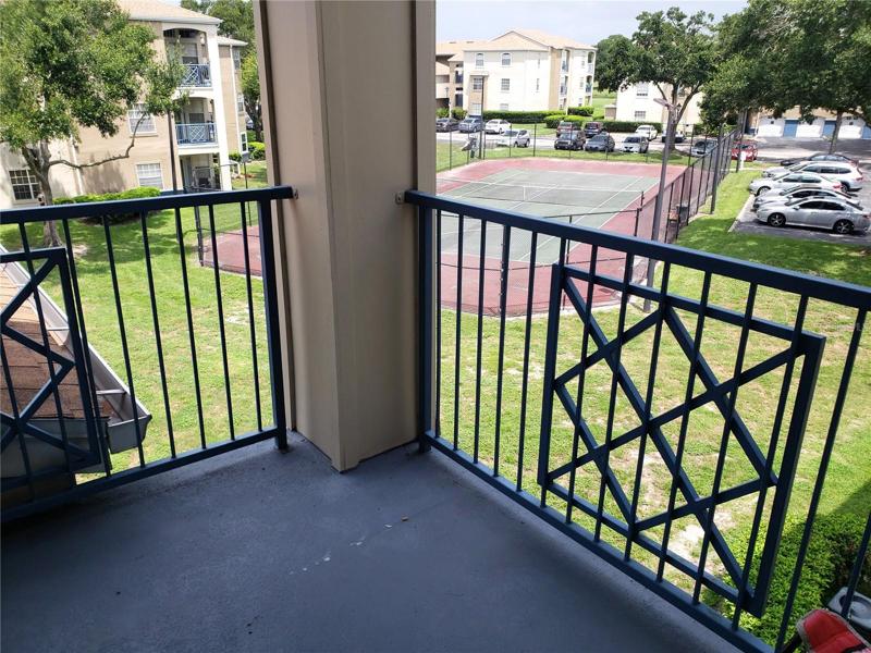Covered Patio which looks out on Tennis Court