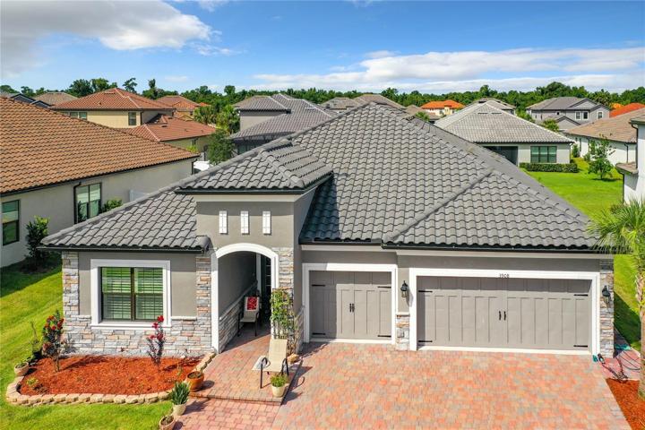 Three car garage and a barrel tile roof