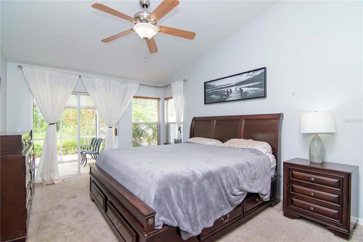 master bedroom with sliders leading out to patio