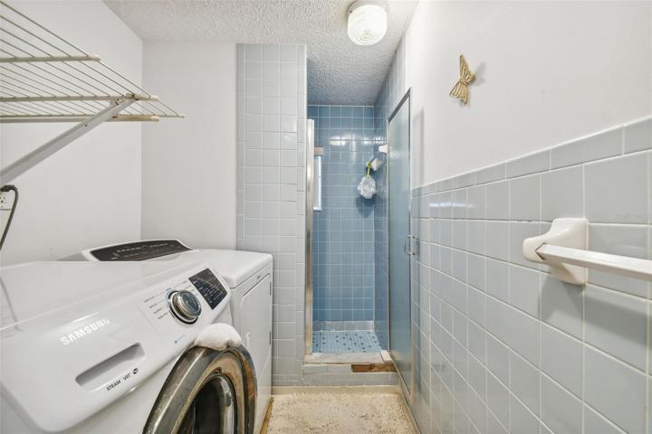 Hall Bathroom with washer and dryer.