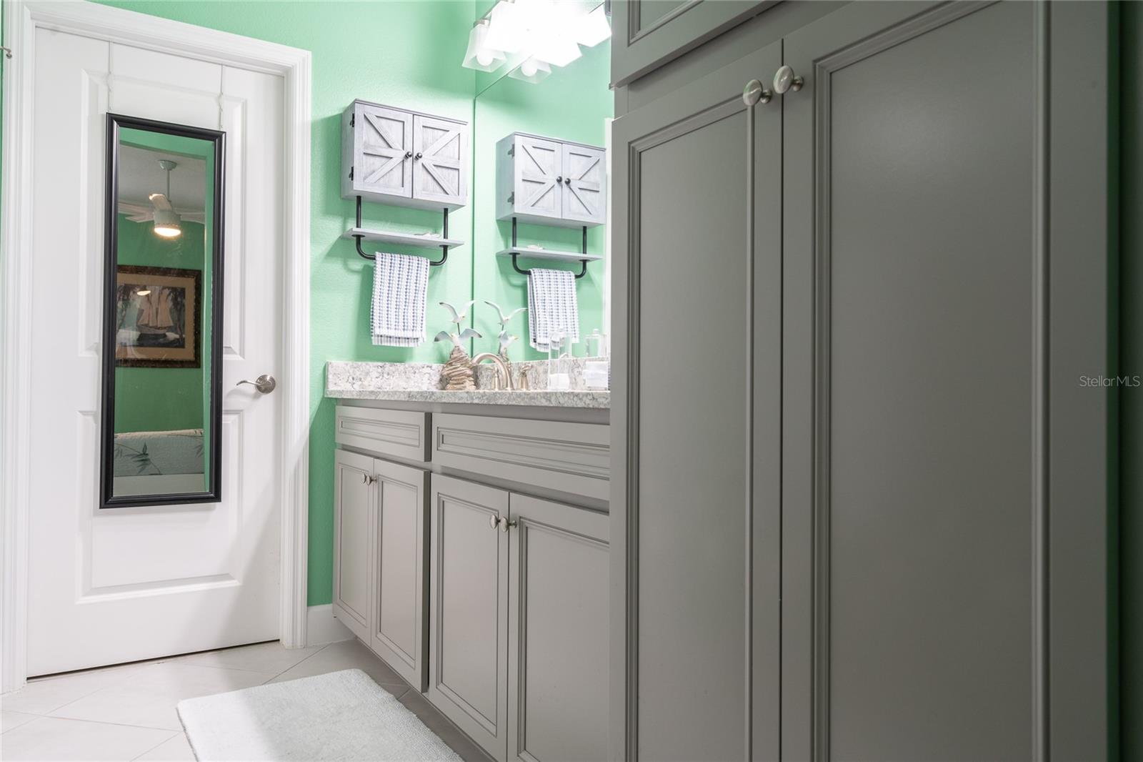 master bath with lots of cabinets.