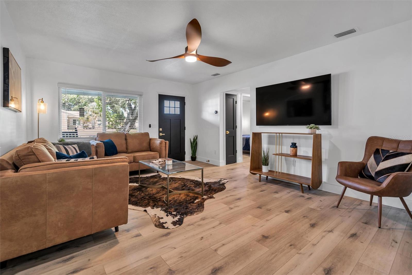 Living room with new ceiling fan (60 inch tv featured)