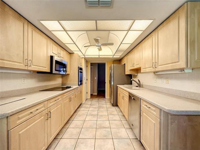 Corian countertops compliments the wood cabinets