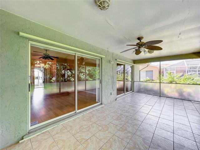 Living room sliders opens to lanai to provide extra room for entertaining.