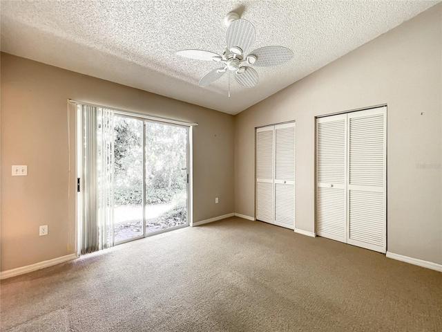 Nice & bright guest room with sliders that let the natural light shine through. Plenty of storage space